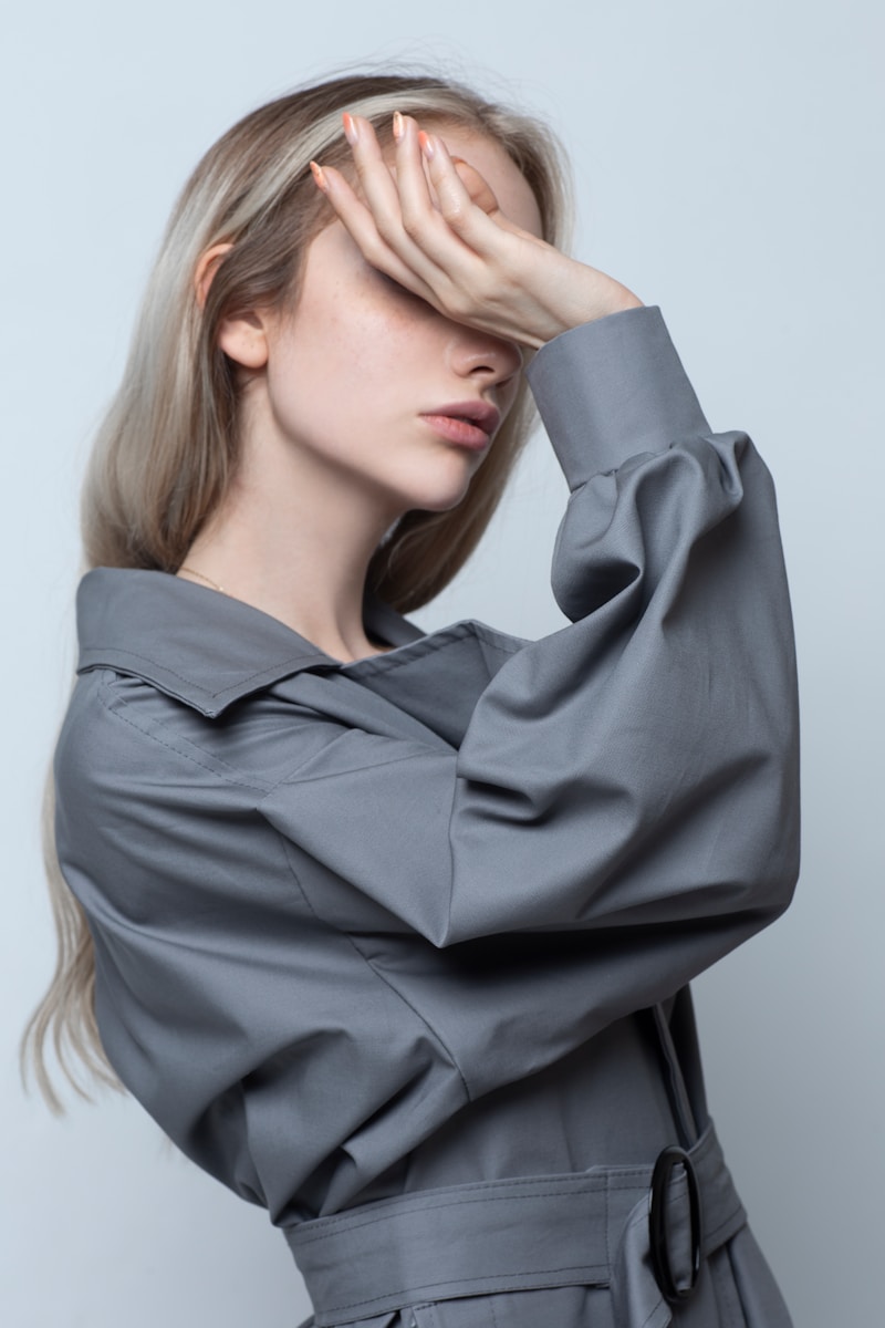 woman in black long sleeve shirt covering her face